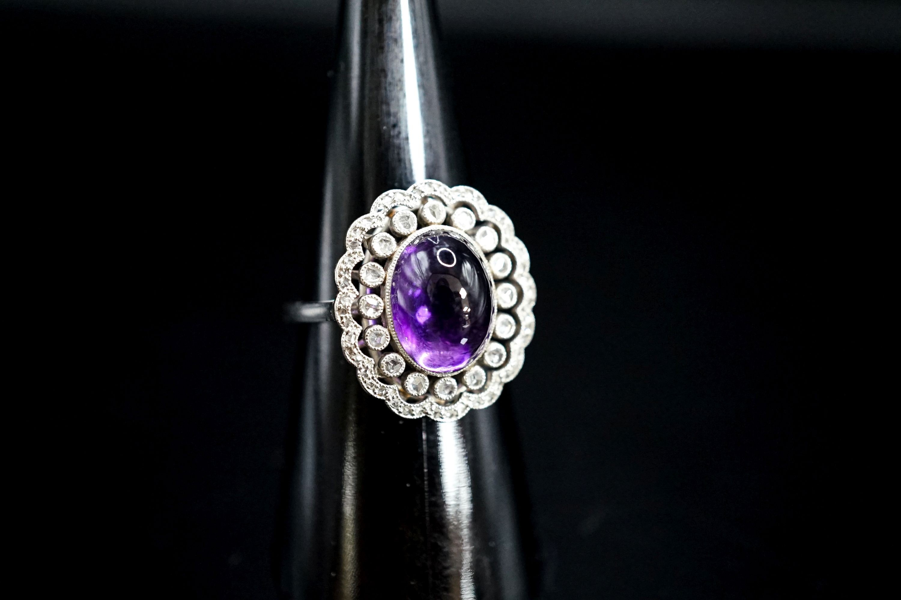 A 1920's white metal, cabochon amethyst and rose cut diamond ring, size M, gross weight 5.9 grams.